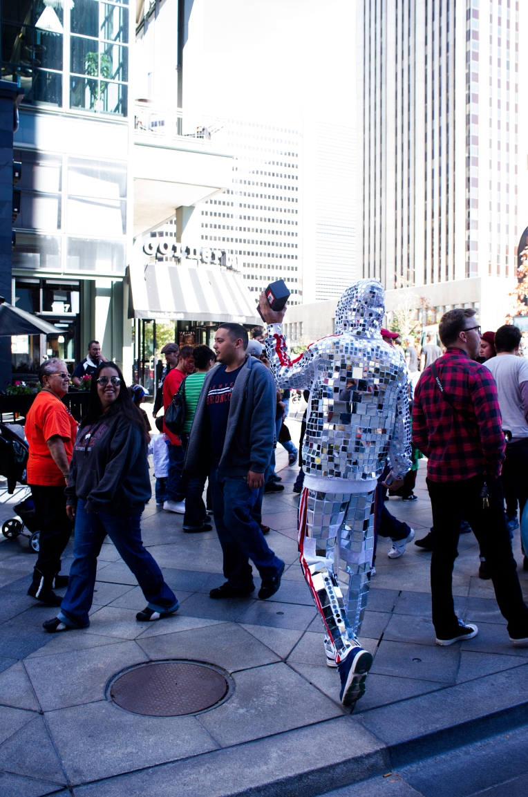 DENVER,Colo.-October 18,2013-A man in a mirror-laden jumpsuit dances to his bluetooth speaker on the 16th Street Mall. 